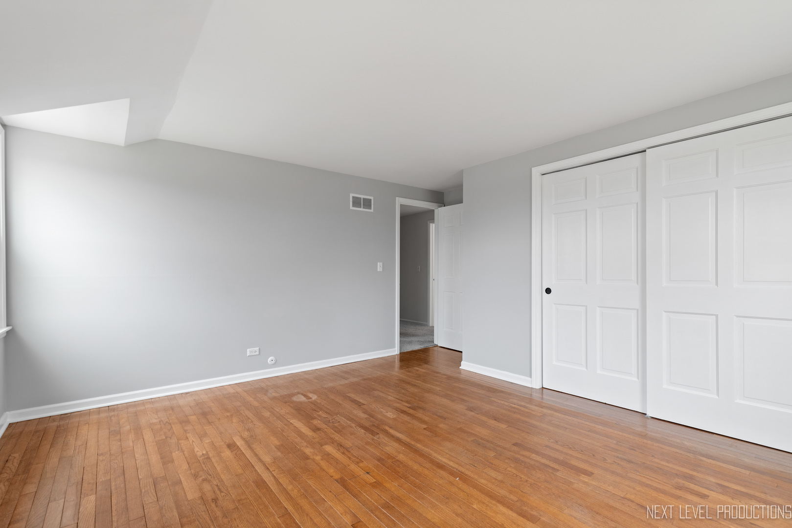 N235 Winfield Road Winfield, IL 60190 - Photo 16 of 37 a view of an empty room with wooden floor