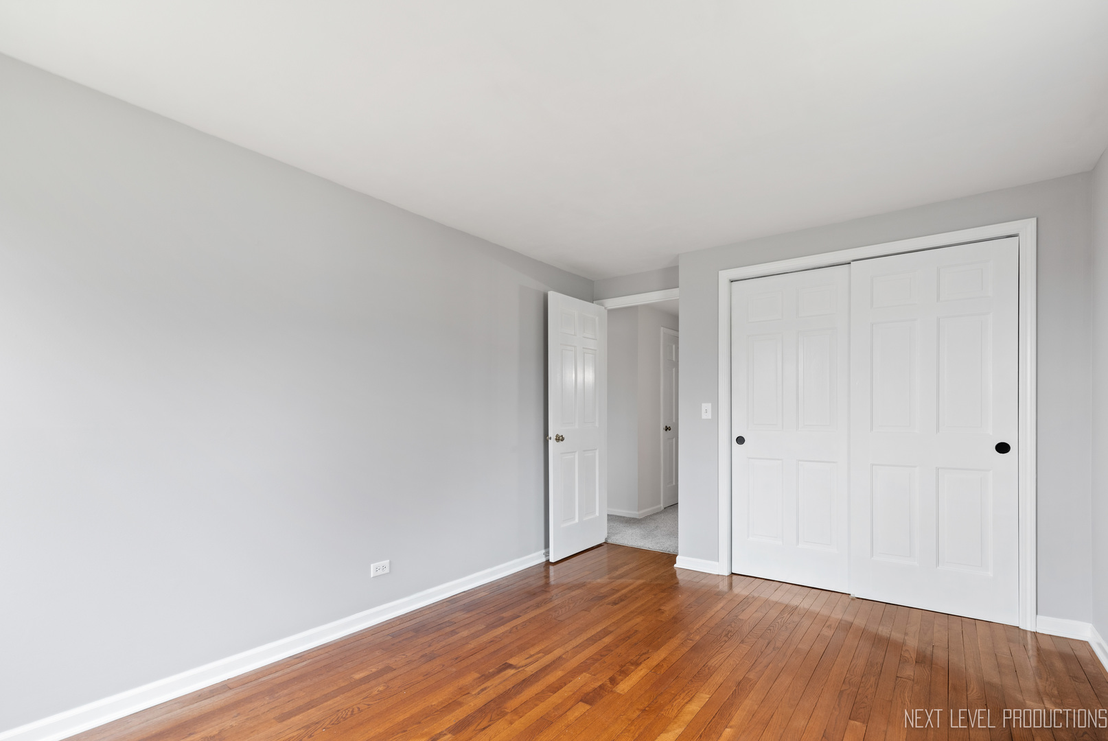 N235 Winfield Road Winfield, IL 60190 - Photo 19 of 37 a view of an empty room with wooden floor