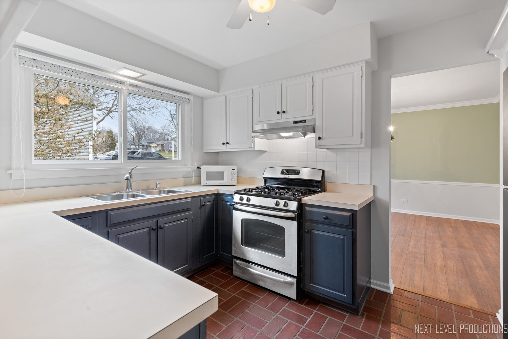 N235 Winfield Road Winfield, IL 60190 - Photo 7 of 37 a kitchen with a stove a sink and a window