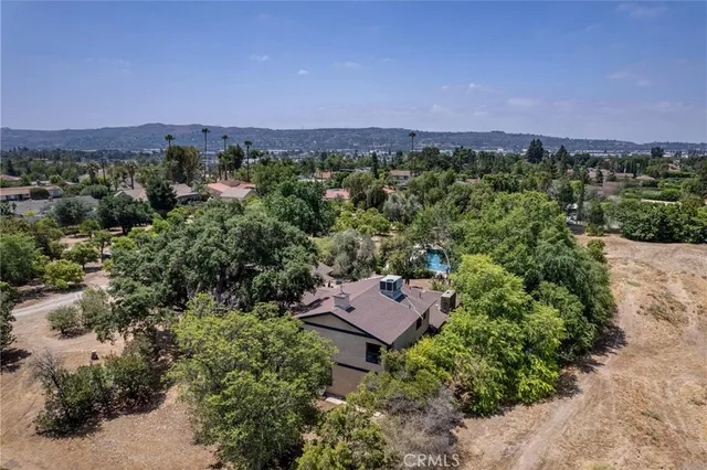 a view of a city with lush green forest