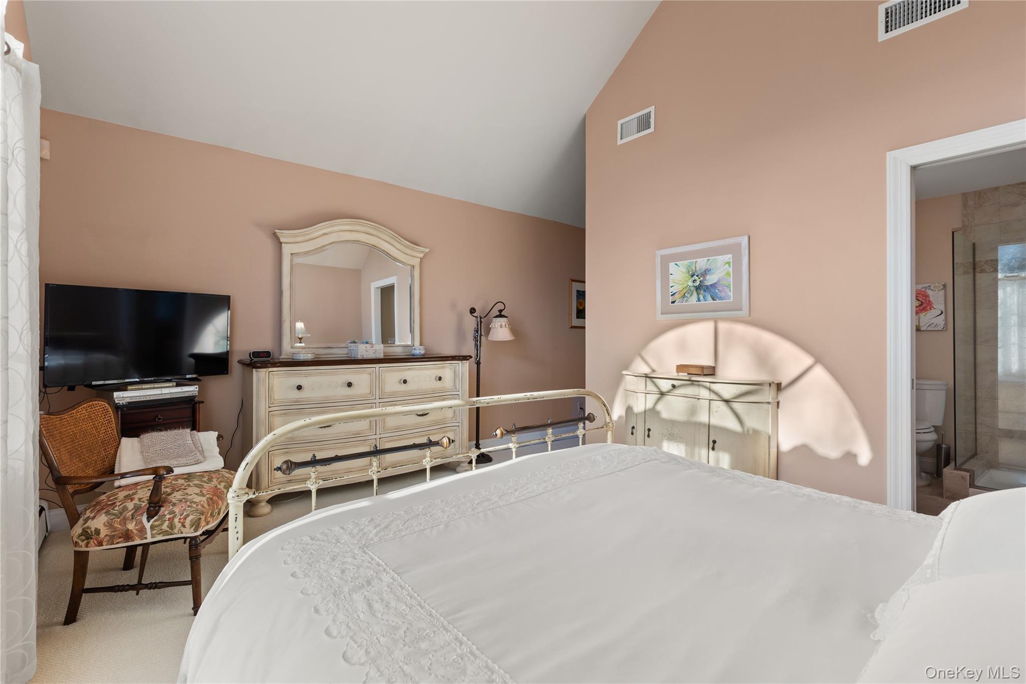 5 A Bay Road East Patchogue, NY 11772 - Photo 12 of 27 Bedroom with carpet, high vaulted ceiling, and connected bathroom