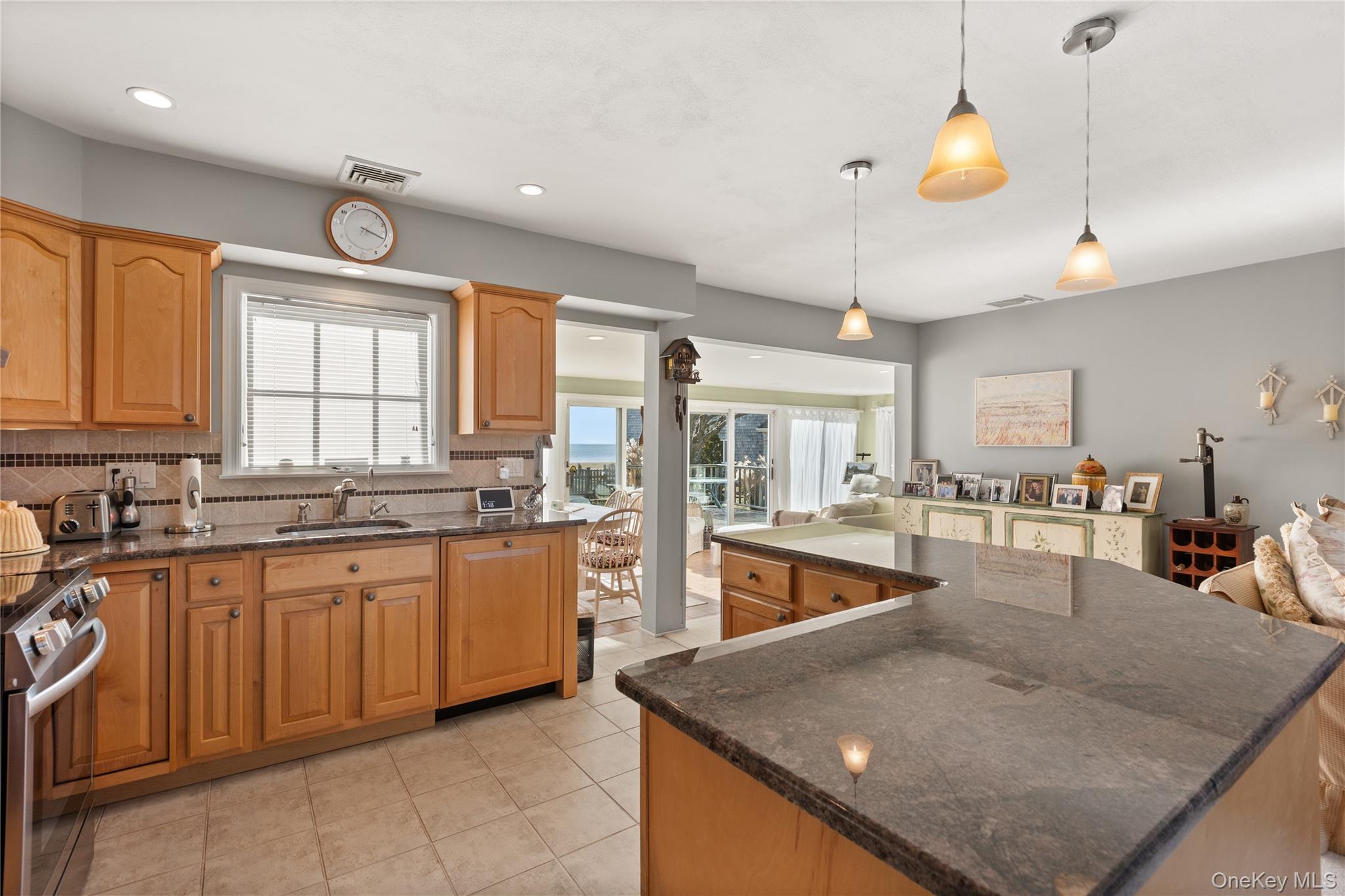 5 A Bay Road East Patchogue, NY 11772 - Photo 18 of 27 Kitchen featuring dark stone countertops, electric stove, a kitchen island, backsplash, and recessed lighting