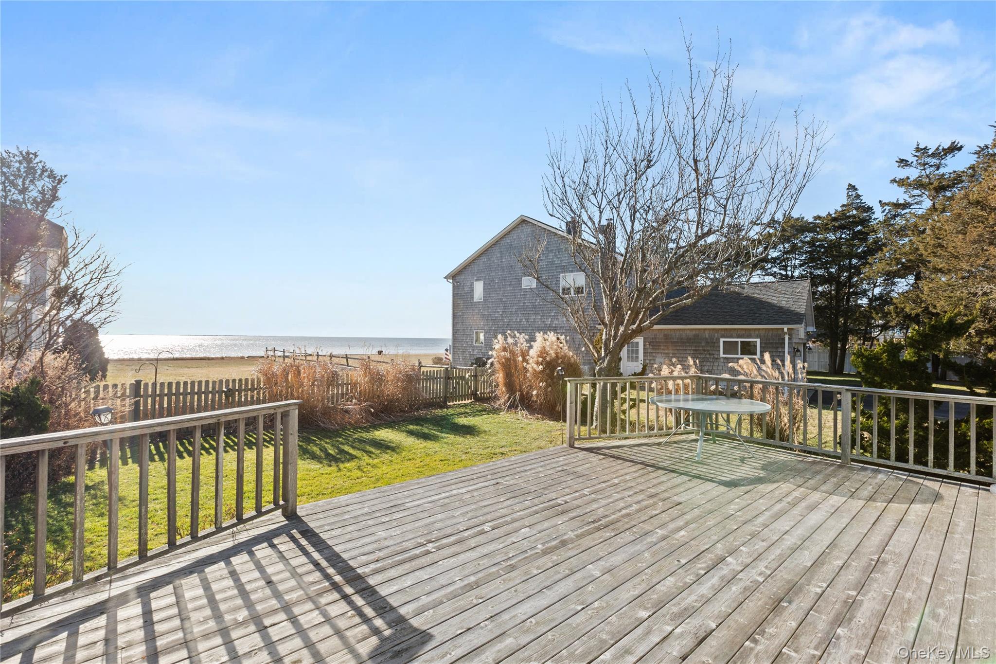5 A Bay Road East Patchogue, NY 11772 - Photo 24 of 27 Wooden terrace with a water view and a fenced backyard