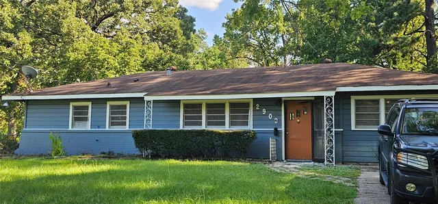 a view of a house with backyard porch and sitting area