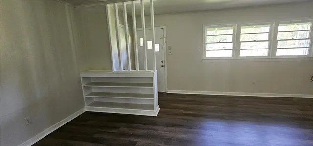a view of wooden floor and windows in a room