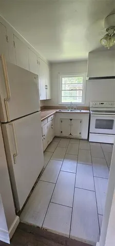 a kitchen with a cabinets and a refrigerator