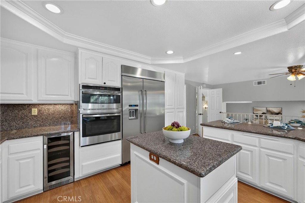 2935 Bluebell Avenue Brea, CA 92821 - Photo 10 of 38 Beautiful kitchen with granite countertops, breakfast bar, stainless steel appliances, and an oversized refrigerator
