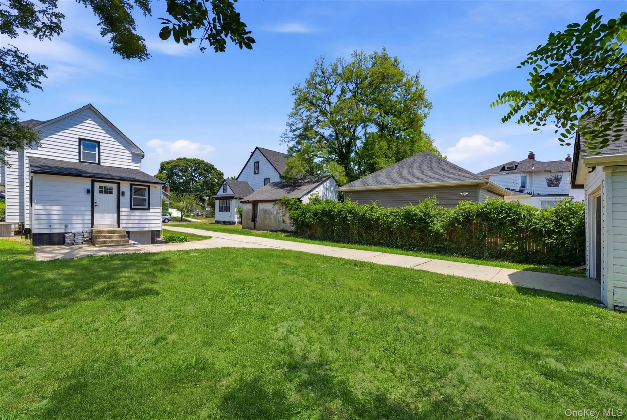 135 Whaley Street Freeport, NY 11520 - Photo 35 of 38 a front view of a house with yard and green space