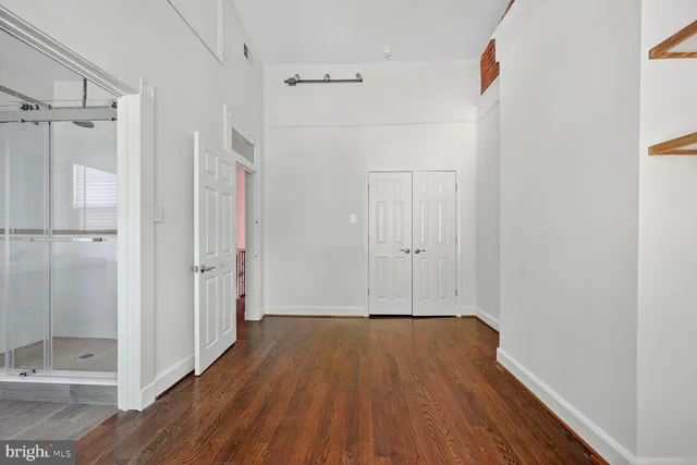 a bathroom with a sink and mirror with toilet