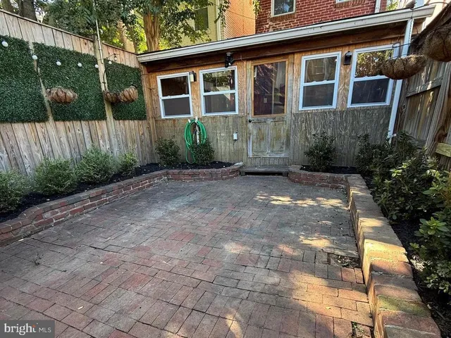 a view of a yard with wooden fence