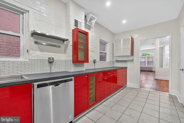 a kitchen with stainless steel appliances a sink stove and cabinets