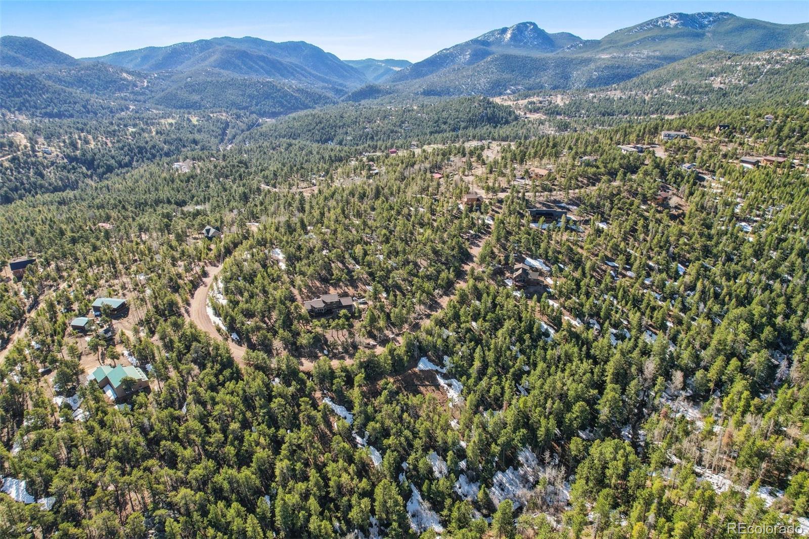 854 Crescent Lake Road Golden, CO 80403 - Photo 11 of 11 a view of a forest with mountains in the background