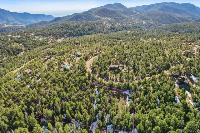 a view of a lush green hillside and a houses