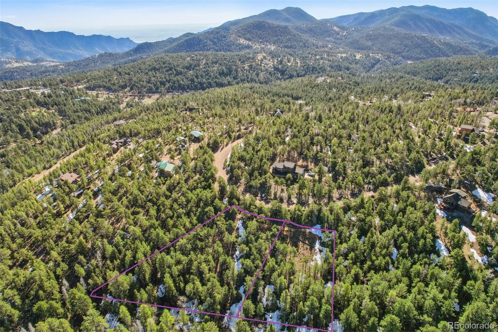854 Crescent Lake Road Golden, CO 80403 - Photo 4 of 11 a view of a lush green hillside and a houses