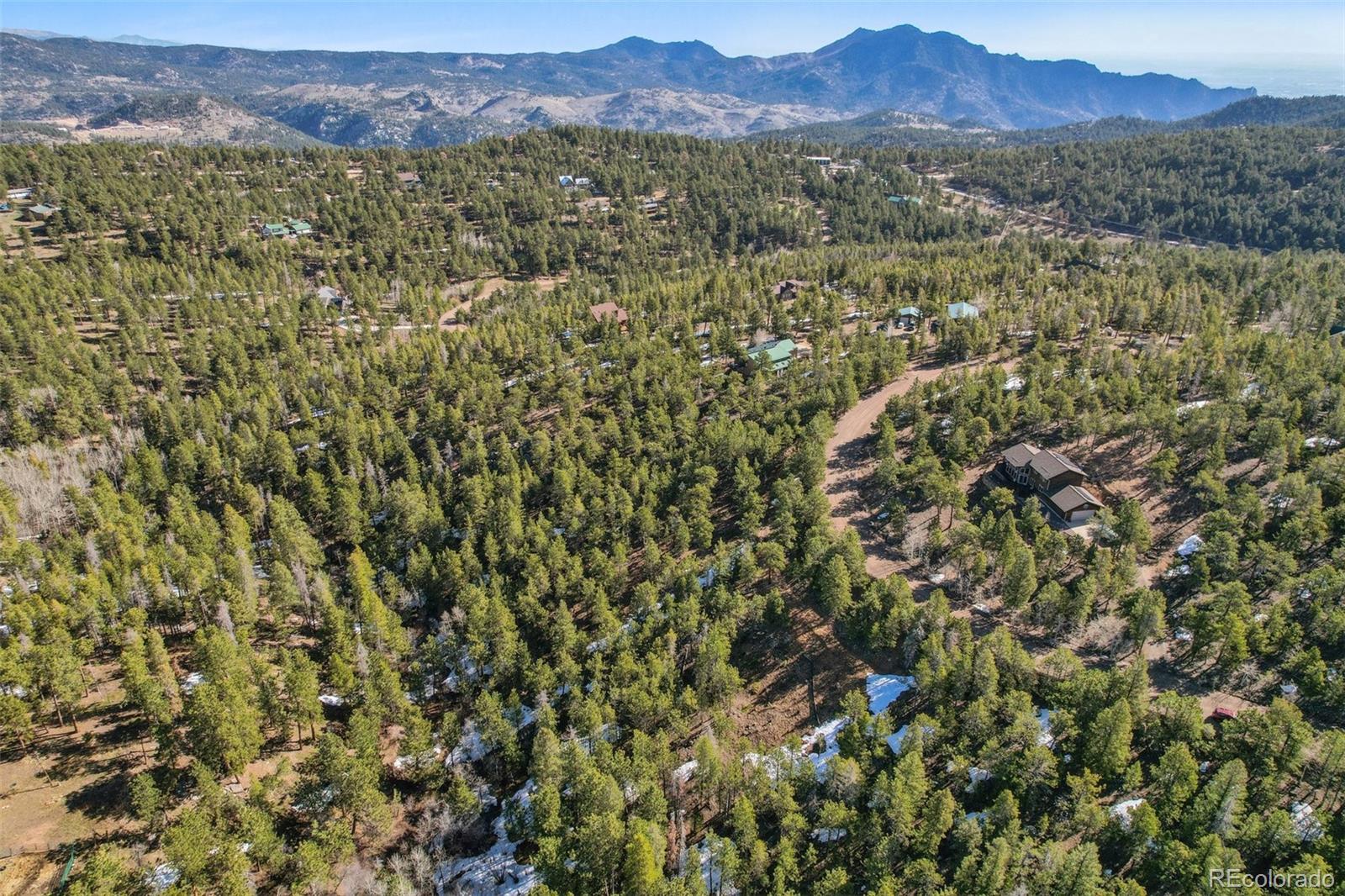 854 Crescent Lake Road Golden, CO 80403 - Photo 10 of 11 a view of a lush green field with mountains in the background
