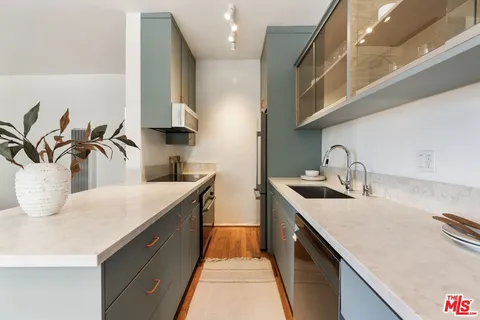 a kitchen with a sink and cabinets