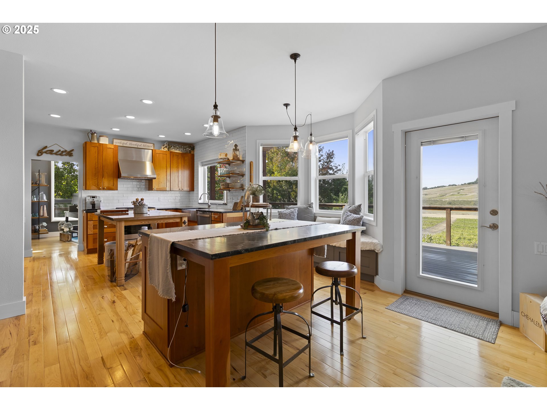 13631 Northeast Kinney Road Newberg, OR 97132 - Photo 11 of 48 a kitchen with stainless steel appliances granite countertop table chairs and a view of living room