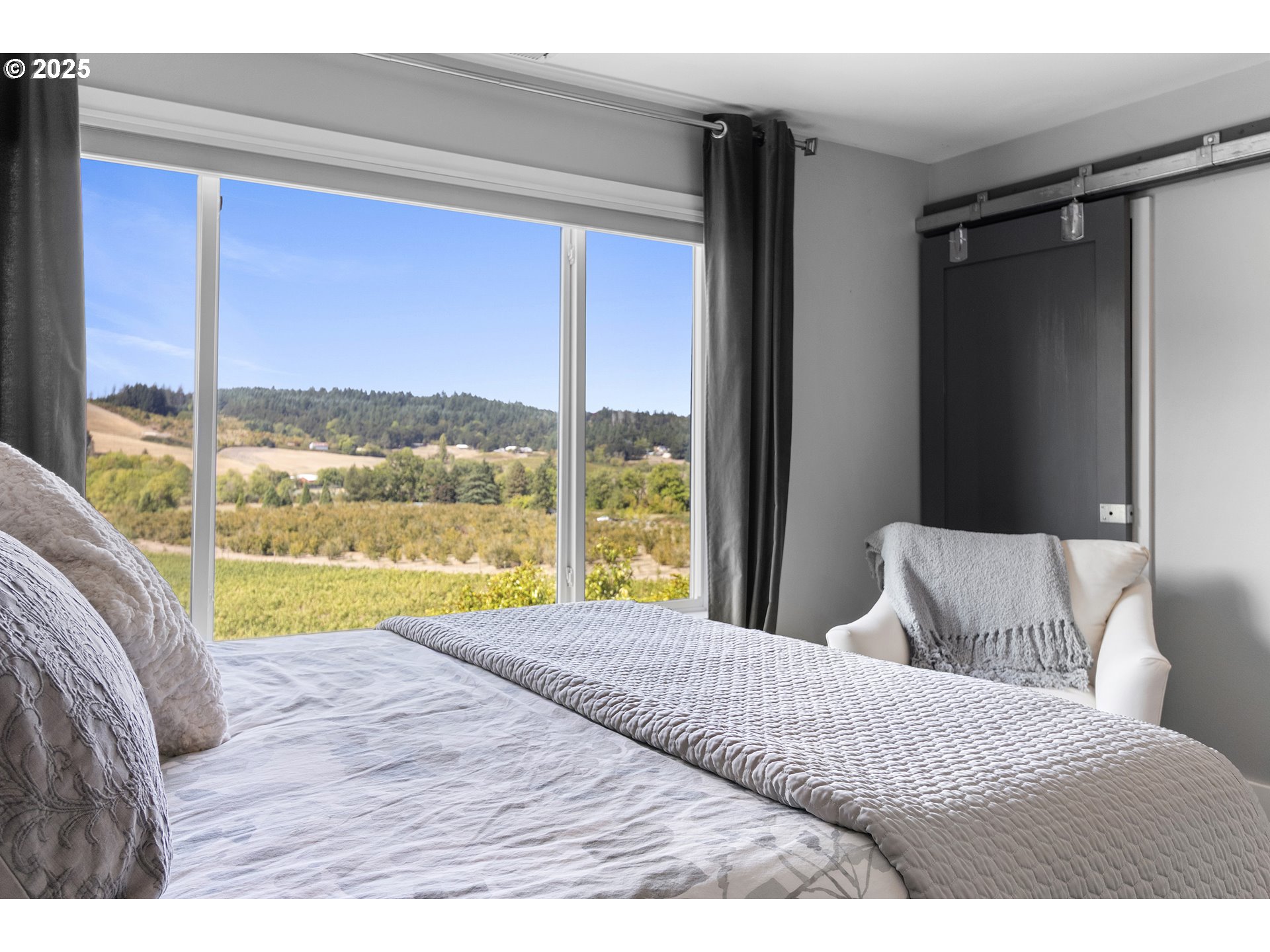 13631 Northeast Kinney Road Newberg, OR 97132 - Photo 18 of 48 a bedroom with a large bed and a large window