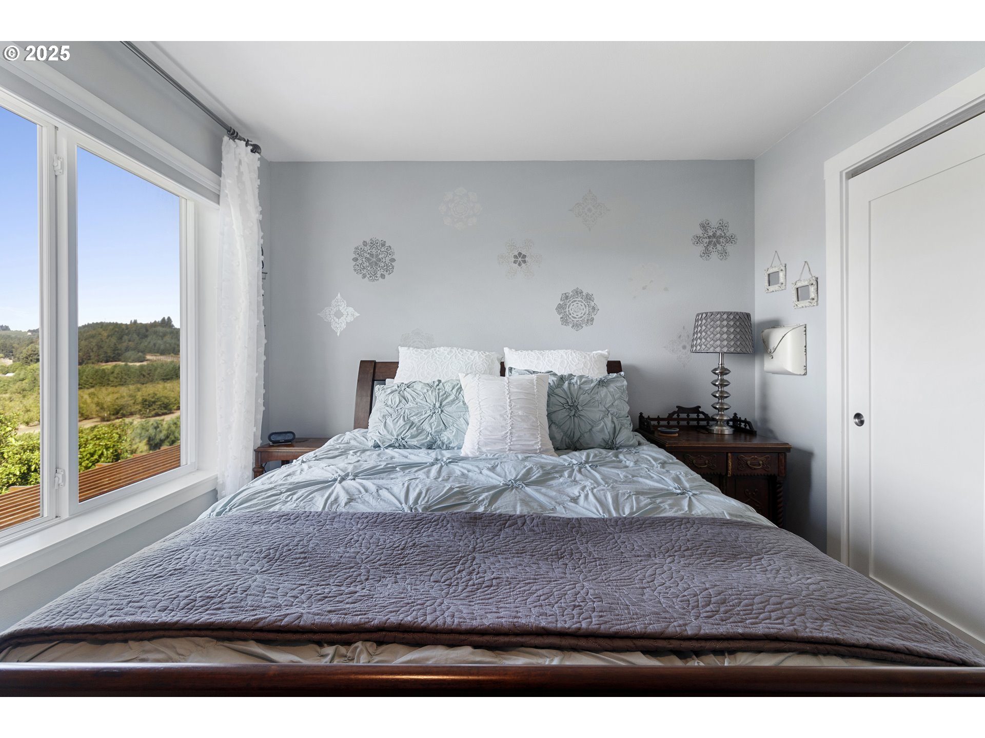 13631 Northeast Kinney Road Newberg, OR 97132 - Photo 24 of 48 a large bed sitting in a bedroom next to a window