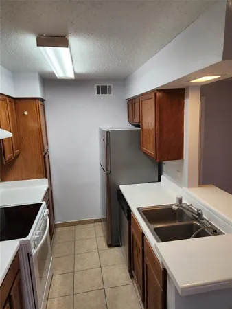 a kitchen with a sink and a stove top oven