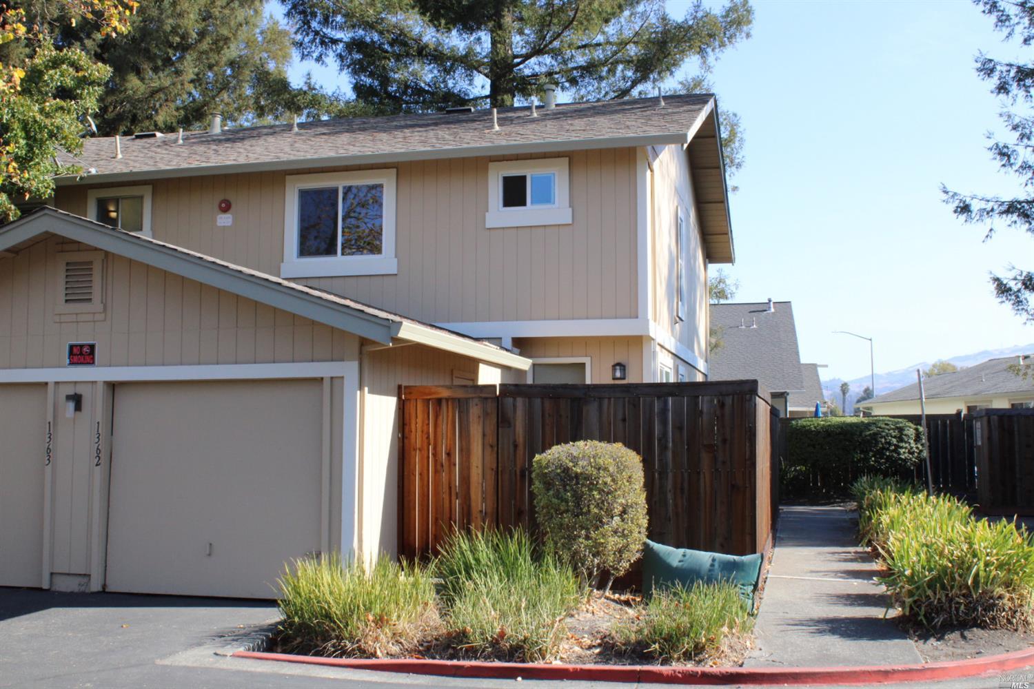 a view of a house with a yard and sitting area