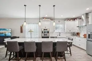 a large kitchen with a table and chairs