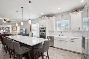 a large kitchen with a table and chairs