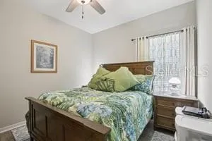 a bed sitting in a bedroom next to a window