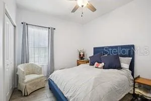 a bedroom with a bed and a couch