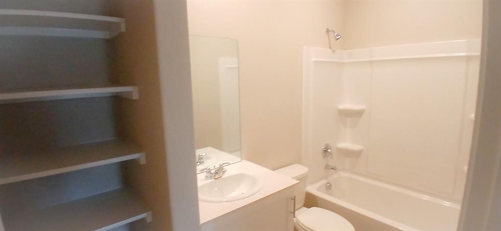 309 Potato Street Keene, TX 76059 - Photo 8 of 16 a bathroom with a toilet and shower