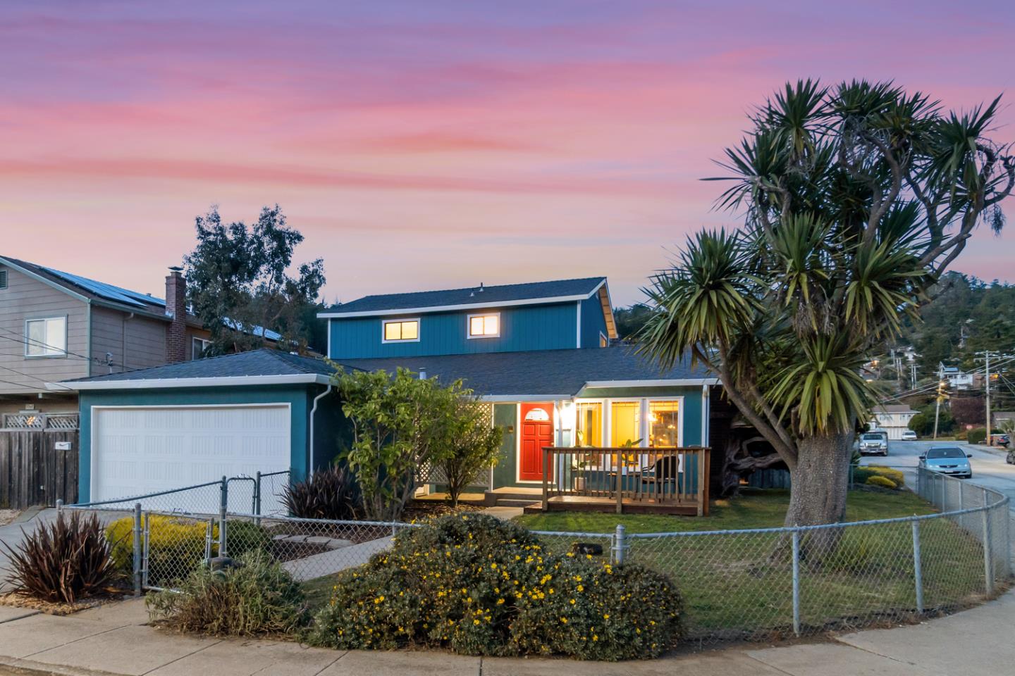 a view of a house with a backyard and a tree