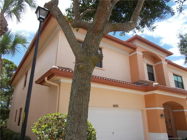 a kitchen with granite countertop a refrigerator stove top oven and sink