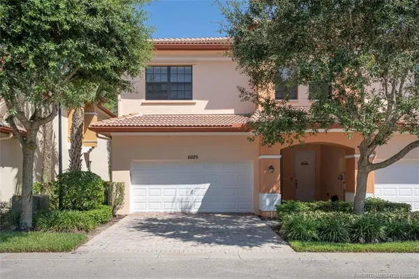 a kitchen with stainless steel appliances granite countertop a sink and a refrigerator