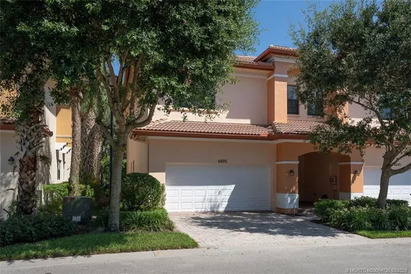 an empty room with windows and ceiling fan