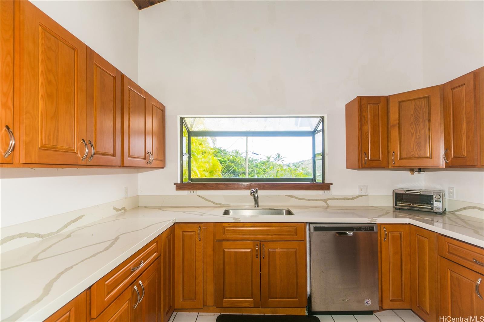 953 Ailuna Street Honolulu, HI 96821 - Photo 18 of 25 a kitchen with stainless steel appliances sink cabinets and window