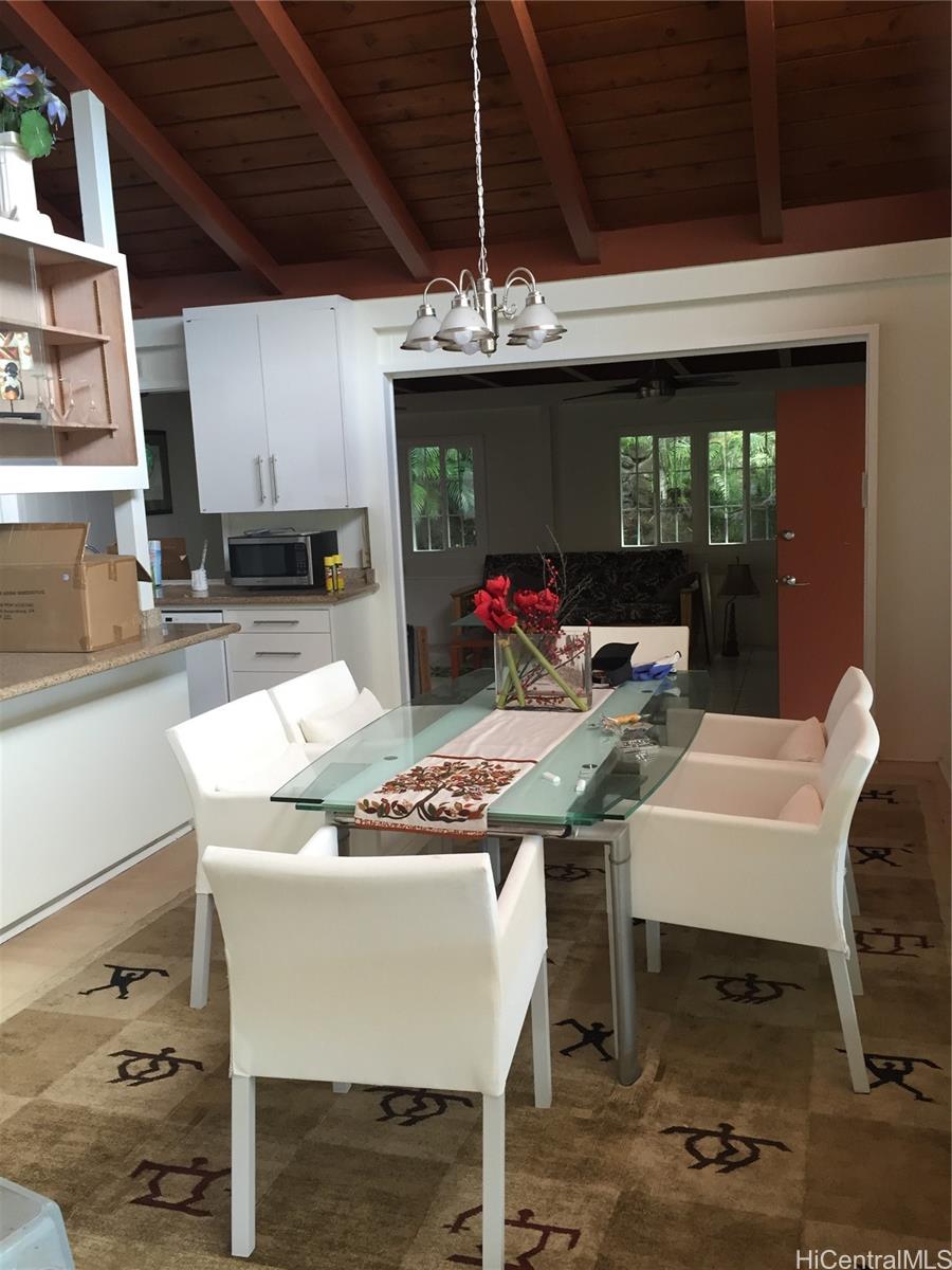 953 Ailuna Street Honolulu, HI 96821 - Photo 4 of 25 a view of a dining room with furniture a fireplace and chandelier