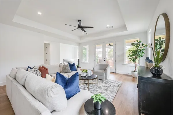 a living room with furniture and a wooden floor