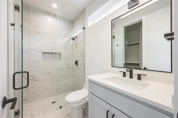 a bathroom with a sink toilet and shower