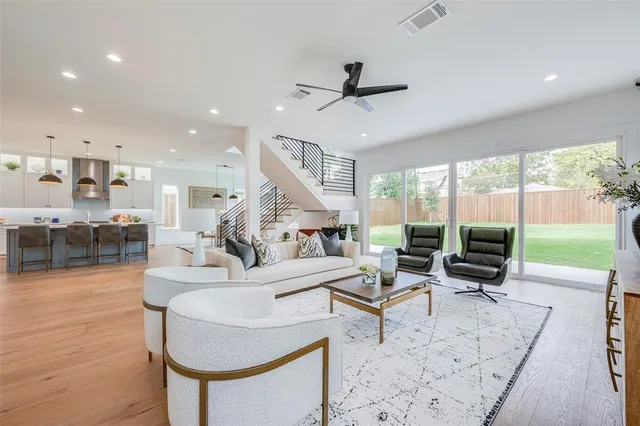 a living room with fireplace furniture and a large window