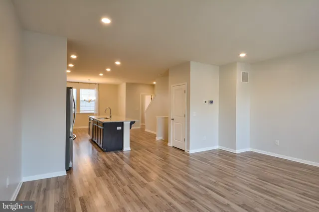 a view of kitchen with refrigerator and windows