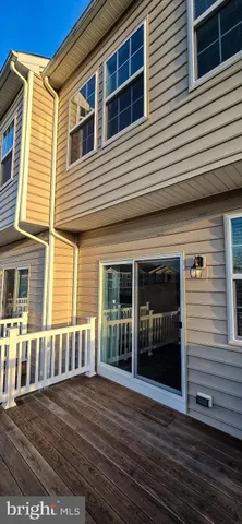 a view of a house with wooden deck