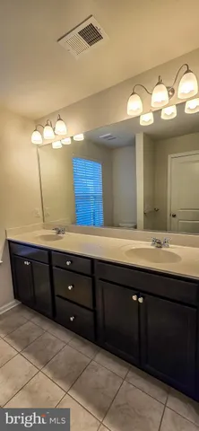 a bathroom with a sink and a large mirror