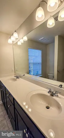 a bathroom with a sink and a large mirror