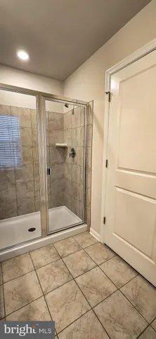 a bathroom with a shower and a sink