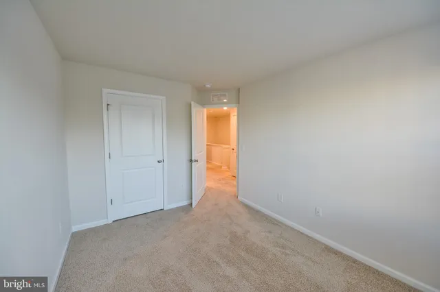 a view of an empty room and a window