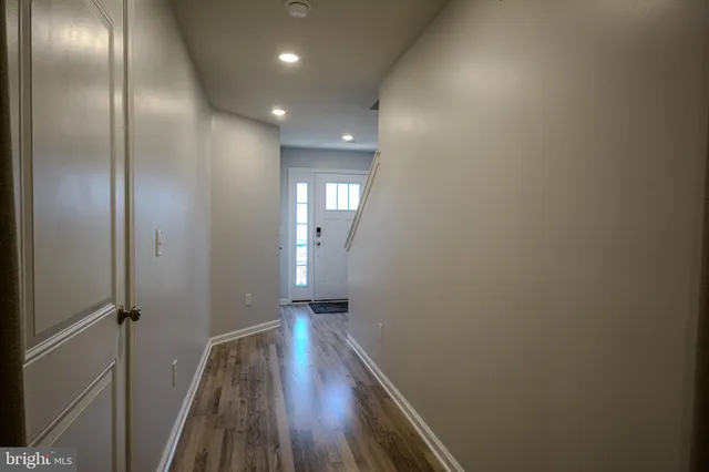 a view of hallway with wooden floor