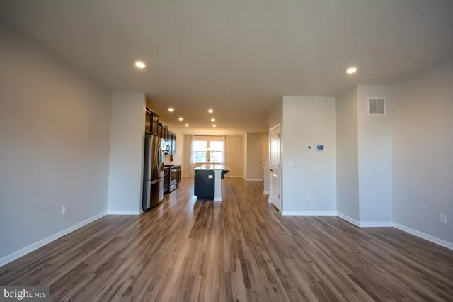a view of a big room with wooden floor and furniture