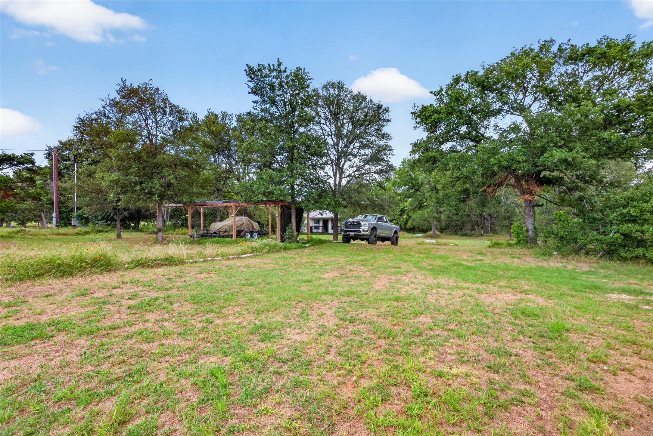 266 Beaver Road Elgin, TX 78621 - Photo 13 of 40 Mature trees and open grassy areas provide a peaceful, natural setting for your private retreat.