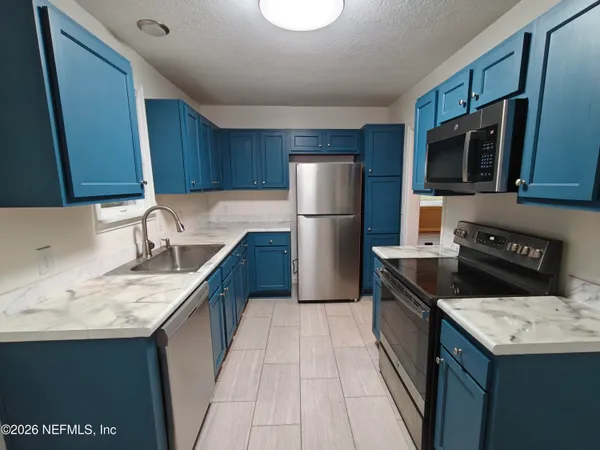 a kitchen with a stove and a microwave