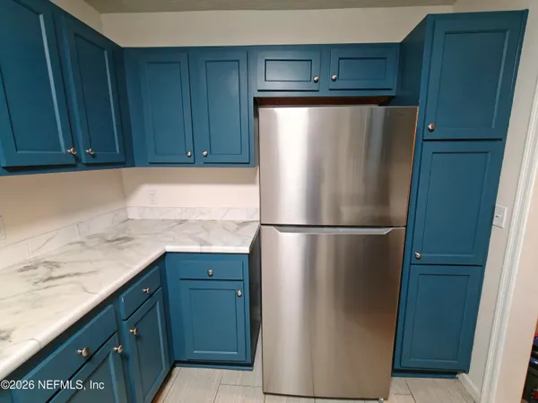 a kitchen with a sink appliances and cabinets
